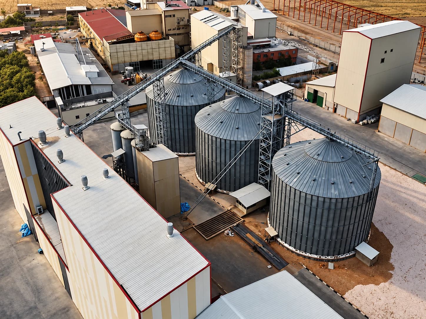 Close aerial view of grain silos with the overhead conveyor gantry